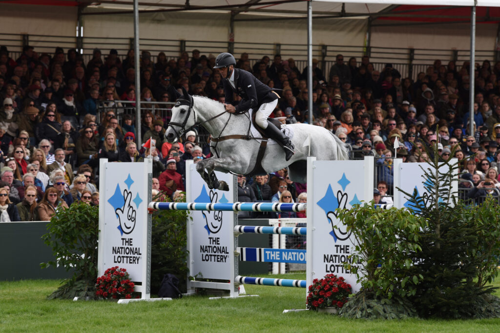 Jockey jumping a gate at Badminton Horse Trials