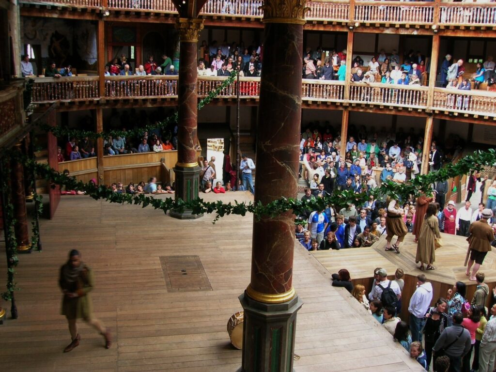 A scene on the Globe Theatre stage with the audience in the background